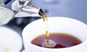 Tea being poured into a cup, suggesting a calm and informal space for conversation.